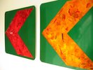 Vibrant red green yellow paintings on arrow road signs