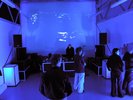 people enjoying space, lit purple/blue