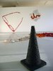 Witches hat, in charcoal colouring, large glasses and coloured trail in background