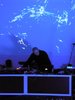 dj in front of blue and purple projections