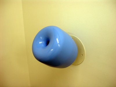 blue circular holder against yellow wall