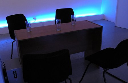 desk and office chairs, blue glow in background