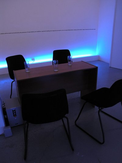 desk and office chairs, blue glow in background