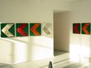 colourful green orange and silver install on road arrows points left