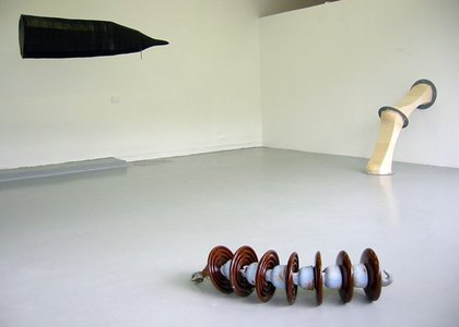 objects in situ, spirally one in forefront, pipes and tent shape in back