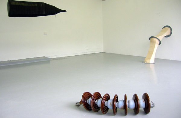 objects in situ, spirally one in forefront, pipes and tent shape in back