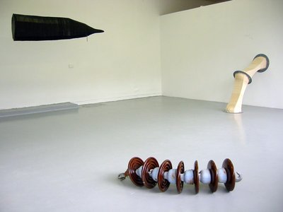 objects in situ, spirally one in forefront, pipes and tent shape in back