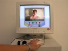 computer, old and beige, with a person on the screen