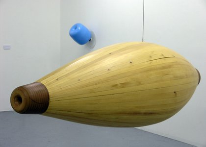 yellow shape like a bowling pin, horizontal and hanging