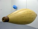 yellow shape like a bowling pin, horizontal and hanging