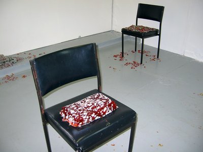 black chairs with painted red texture on them.