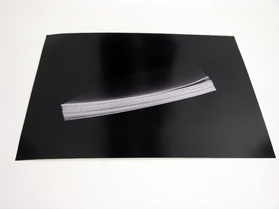 a black image with papers in middle