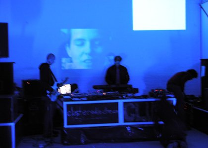 djs in front of face projection purple/blue