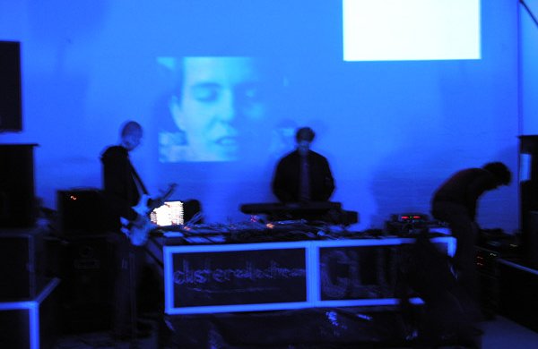 djs in front of face projection purple/blue