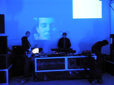 djs in front of face projection purple/blue
