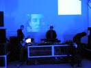 djs in front of face projection purple/blue