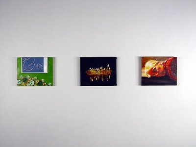 3 small paintings, one is green and blue, the middle is black, and red is the last