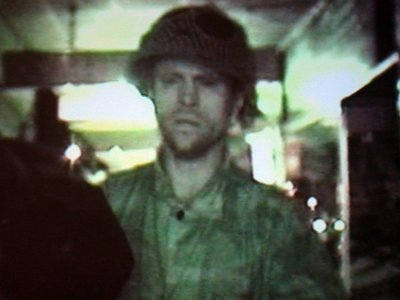 grainy person with beard in shirt