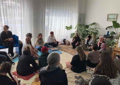 People gathering, listening to a speaker at Earthside Exchange